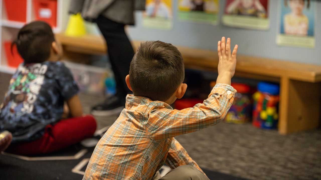 boy-raising-hand-in-class